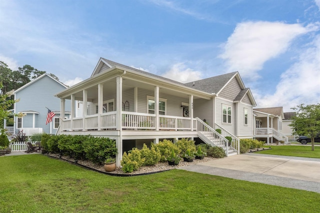 view of home's exterior with driveway, covered porch, and a lawn