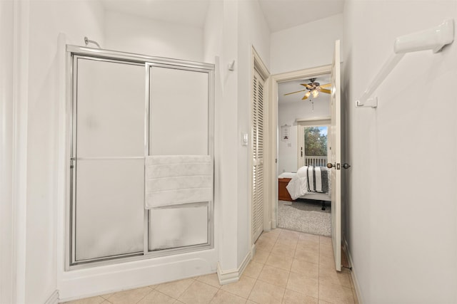 full bath featuring a shower stall, baseboards, a ceiling fan, and tile patterned floors