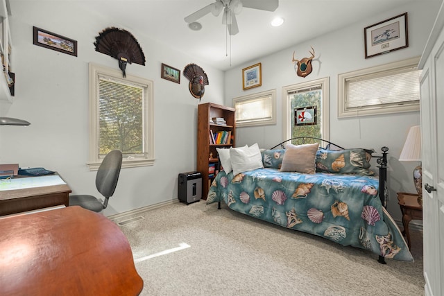 carpeted bedroom with a ceiling fan and baseboards