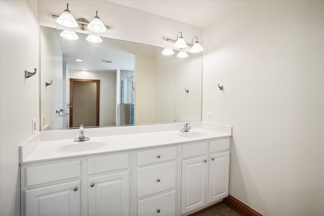 full bathroom with a shower with door, a sink, baseboards, and double vanity