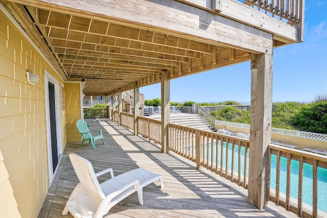 deck with a water view and a fenced in pool