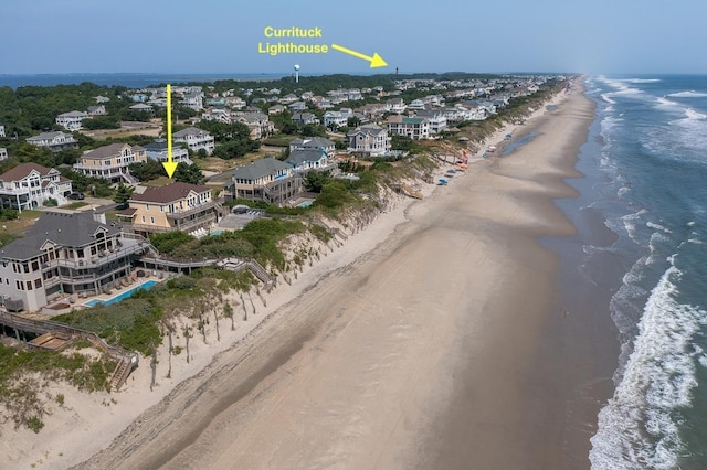 aerial view with a water view and a beach view