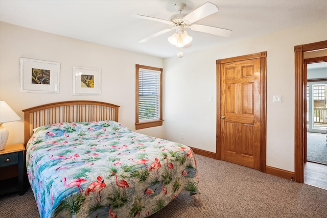 carpeted bedroom with a ceiling fan and baseboards