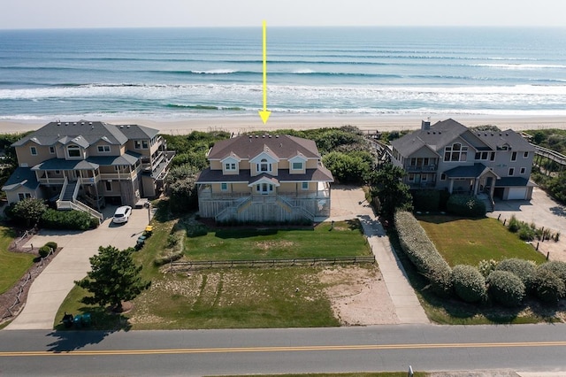 bird's eye view featuring a view of the beach, a water view, and a residential view