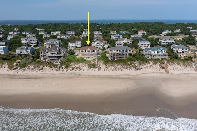 birds eye view of property with a water view and a view of the beach