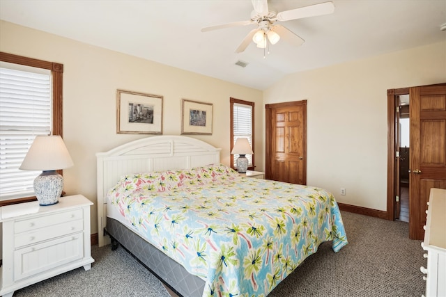 bedroom with baseboards, multiple windows, visible vents, and vaulted ceiling