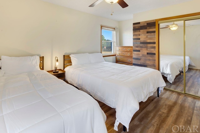 bedroom with a ceiling fan, a closet, and dark wood finished floors