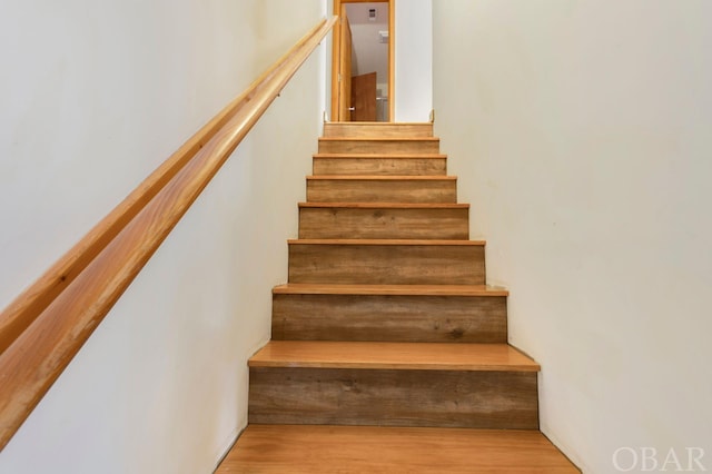 stairs featuring wood finished floors