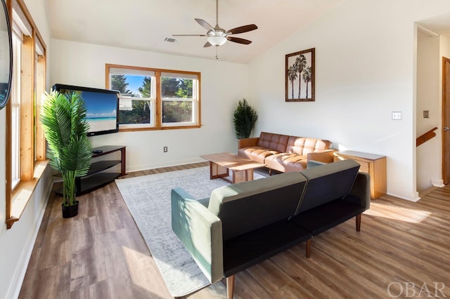 living room with lofted ceiling, ceiling fan, visible vents, and wood finished floors