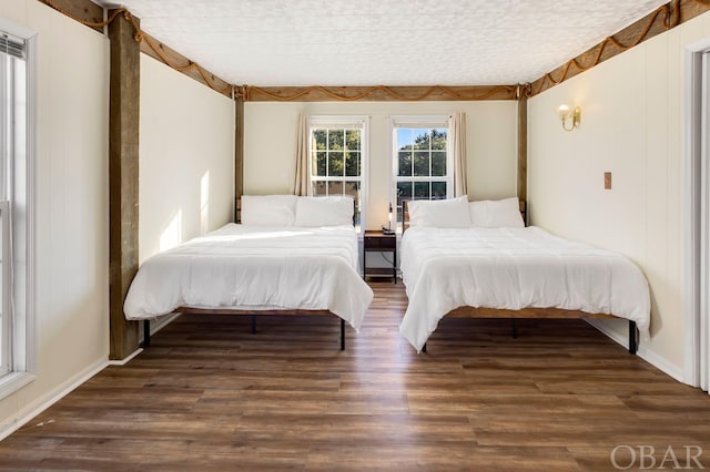 bedroom with dark wood-style floors