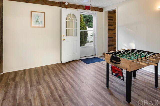 playroom with wood finished floors and baseboards