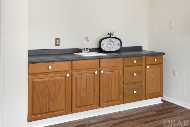 bathroom featuring wood finished floors and a sink