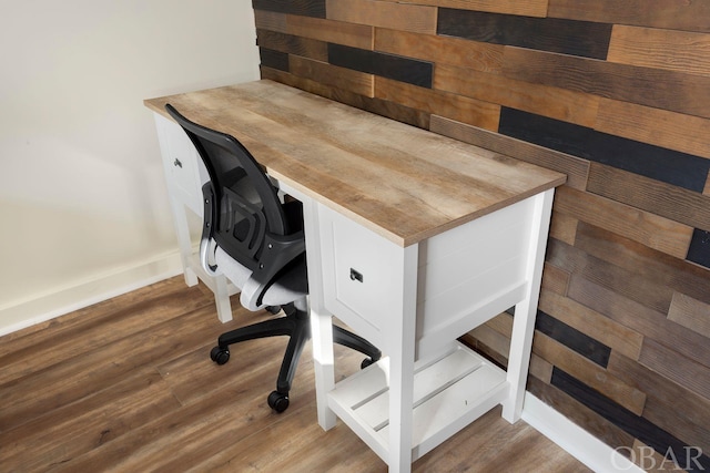 home office featuring baseboards and wood finished floors