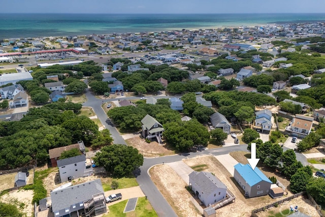 drone / aerial view with a water view and a residential view