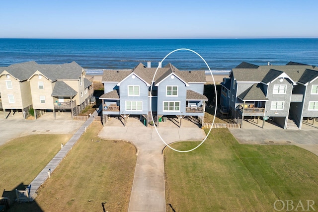 birds eye view of property featuring a water view and a residential view