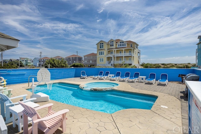 view of pool featuring a patio area and a pool with connected hot tub