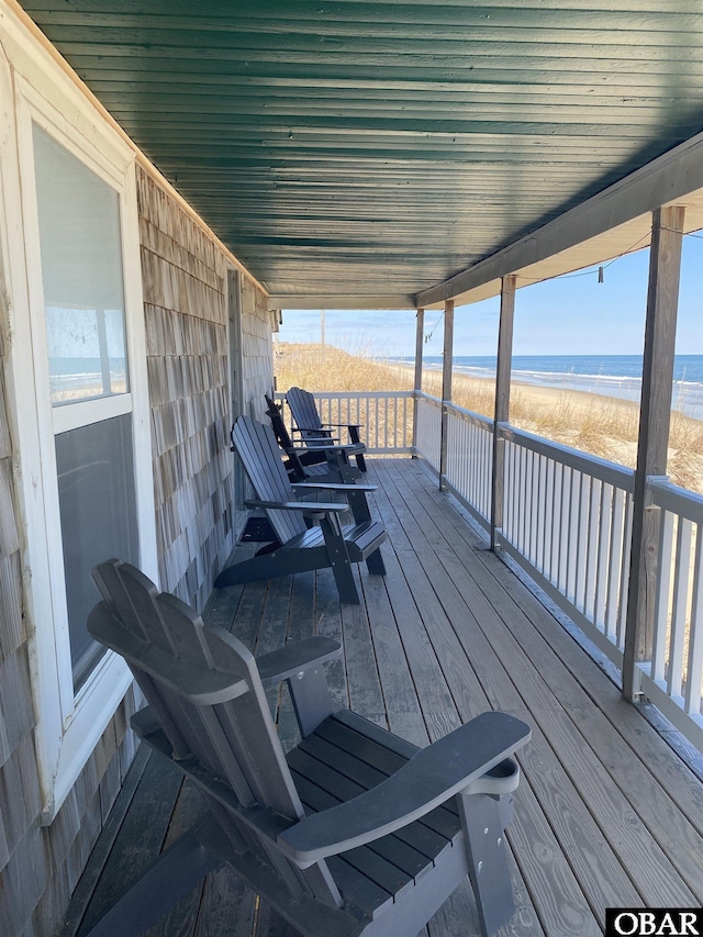 deck featuring a water view and a view of the beach