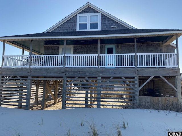 view of front of home with covered porch and a shingled roof