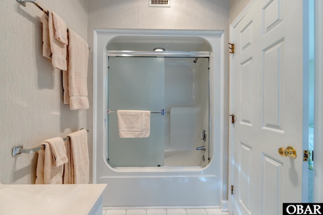 full bath with tile patterned floors, visible vents, and shower / bath combination with glass door