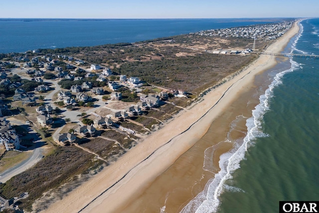 birds eye view of property featuring a view of the beach and a water view