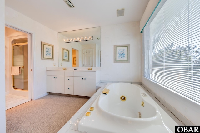 bathroom with vanity, a tub with jets, visible vents, a shower stall, and tile patterned floors