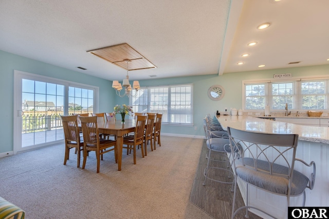 dining room featuring light colored carpet, baseboards, and a wealth of natural light