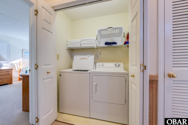 laundry area with laundry area, light colored carpet, and separate washer and dryer