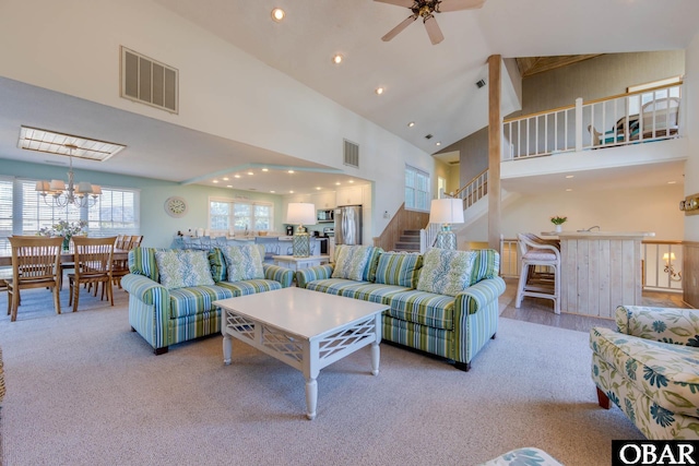 carpeted living room with recessed lighting, visible vents, high vaulted ceiling, and stairway