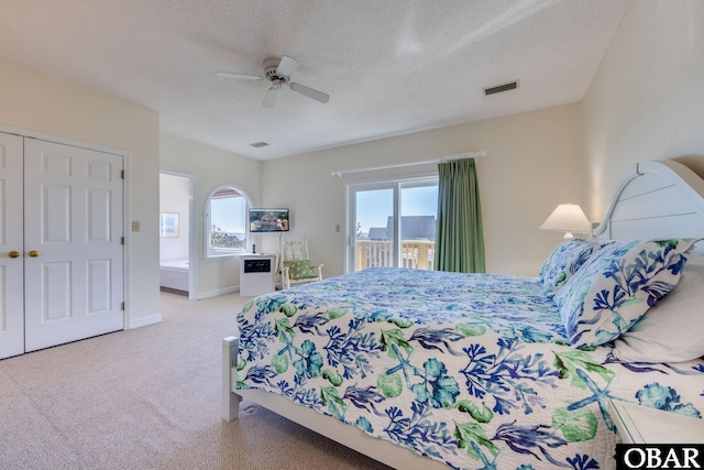 bedroom featuring baseboards, carpet, a textured ceiling, a ceiling fan, and access to outside