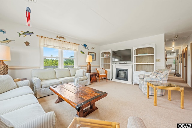 2201 Sandpiper Rd Lot # 13, Corolla, NC 27927 - living room with carpet flooring and a glass covered fireplace