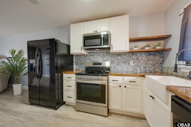 kitchen with open shelves, a sink, black appliances, white cabinets, and backsplash