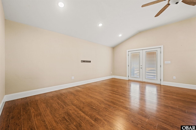 unfurnished room featuring lofted ceiling, wood finished floors, a ceiling fan, baseboards, and french doors