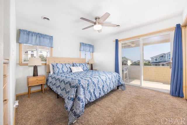 carpeted bedroom with access to outside, multiple windows, visible vents, and ceiling fan