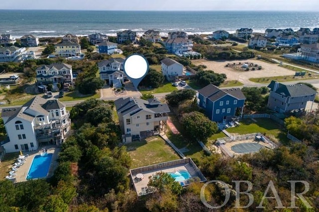 drone / aerial view featuring a water view and a residential view