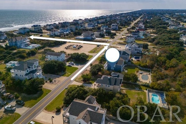 birds eye view of property with a water view and a residential view