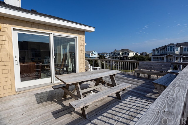 wooden deck featuring a residential view and outdoor dining area