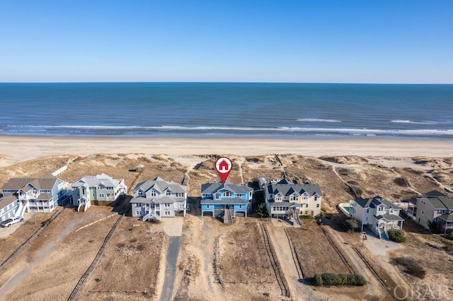 aerial view featuring a residential view, a water view, and a beach view