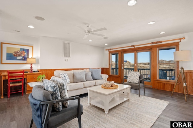 living room featuring recessed lighting, wood finished floors, a ceiling fan, visible vents, and wainscoting