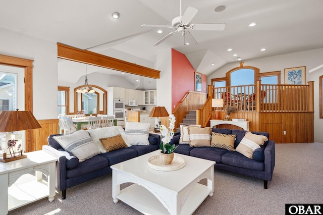 carpeted living room featuring a ceiling fan, lofted ceiling, stairway, and recessed lighting