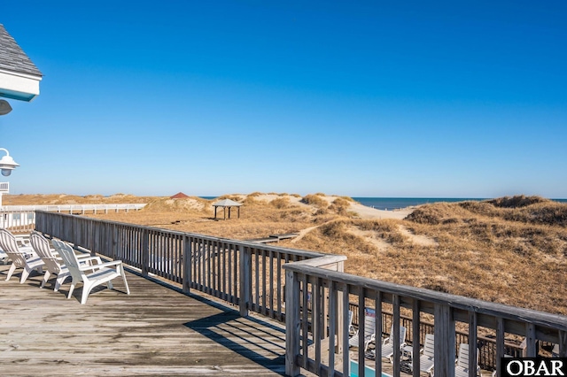 wooden deck featuring a water view