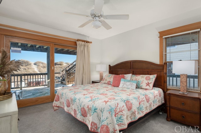 carpeted bedroom with access to exterior, a mountain view, and a ceiling fan