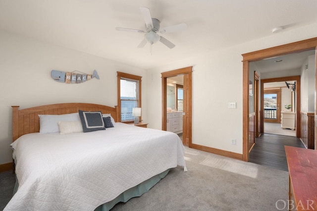 bedroom featuring ceiling fan, carpet, ensuite bath, and baseboards