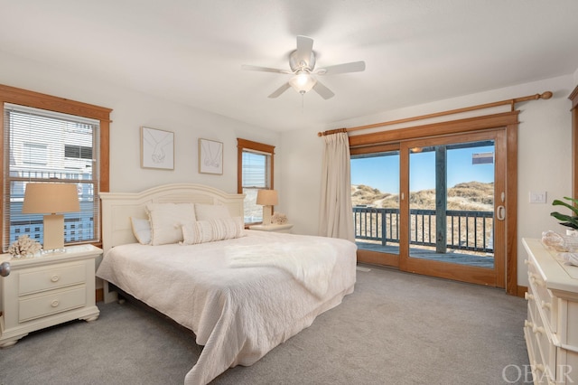 bedroom with ceiling fan, access to outside, a mountain view, and light colored carpet