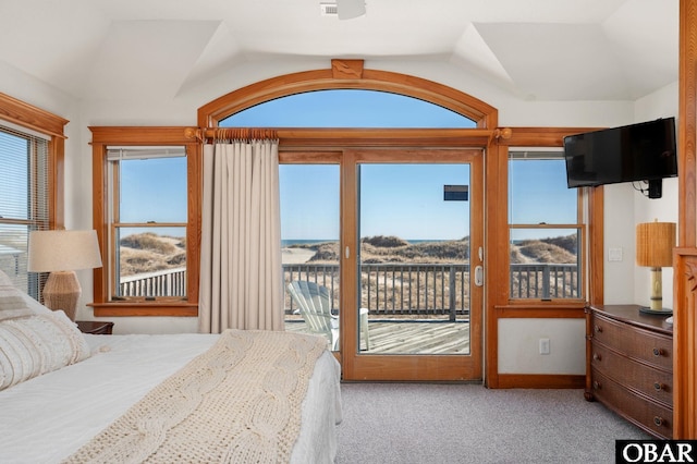 bedroom with lofted ceiling, light carpet, and access to exterior