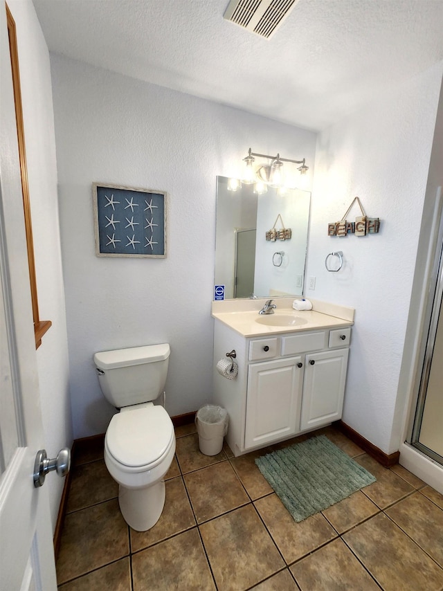 full bath with baseboards, visible vents, toilet, tile patterned flooring, and vanity