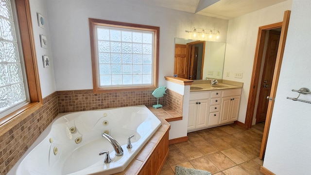 full bathroom with a whirlpool tub, double vanity, a sink, and tile patterned floors