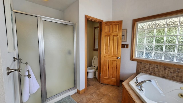 full bath featuring toilet, a stall shower, and a garden tub