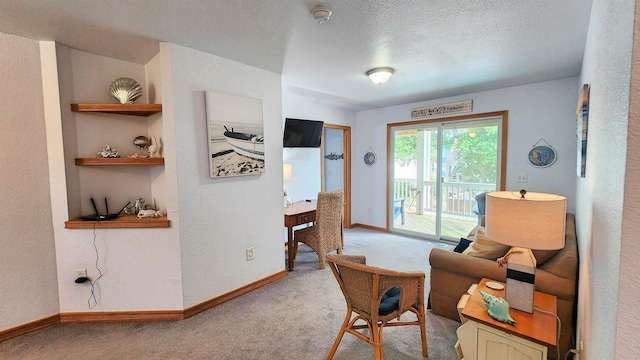 interior space with light carpet, baseboards, a textured ceiling, and built in features