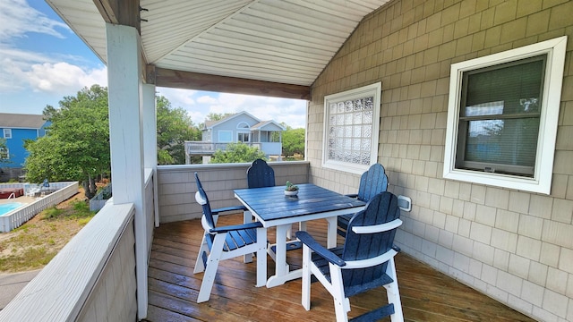 wooden terrace with outdoor dining space