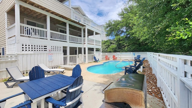 view of swimming pool with a patio, fence, and a fenced in pool